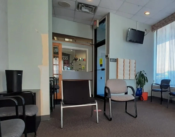 Modern dental office waiting room with comfortable seating and contemporary furnishings.