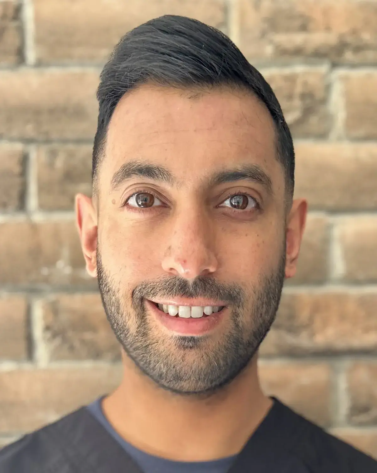 Dr. Gurpal Hoonjan, dentist at Amherst dental practice, smiling portrait.